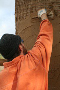 Andrew Morrison Applying Natural Plaster to Straw Bale Walls