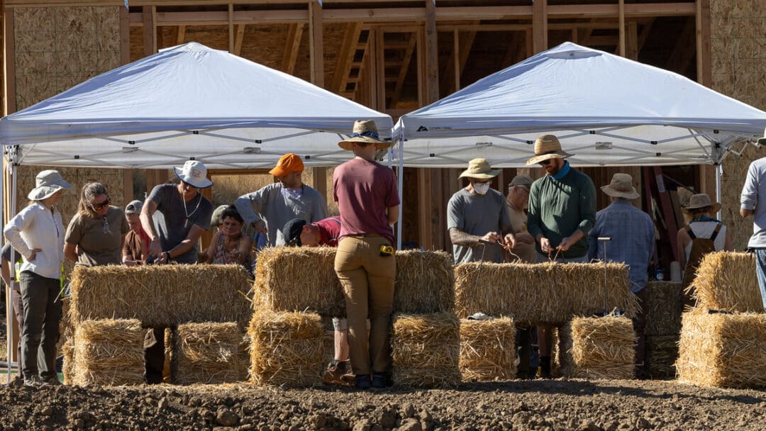 Workshop participants tying straw bales