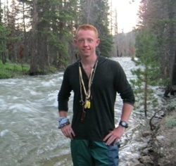 Young man in front of a river