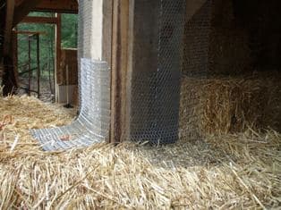 strawbale home construction - using lath to secure bales to back of post