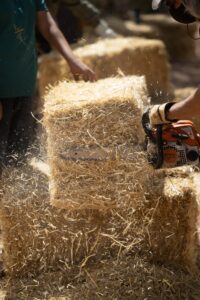 chainsaw shaping a bale