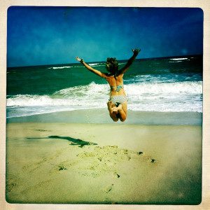 girl jumping on beach