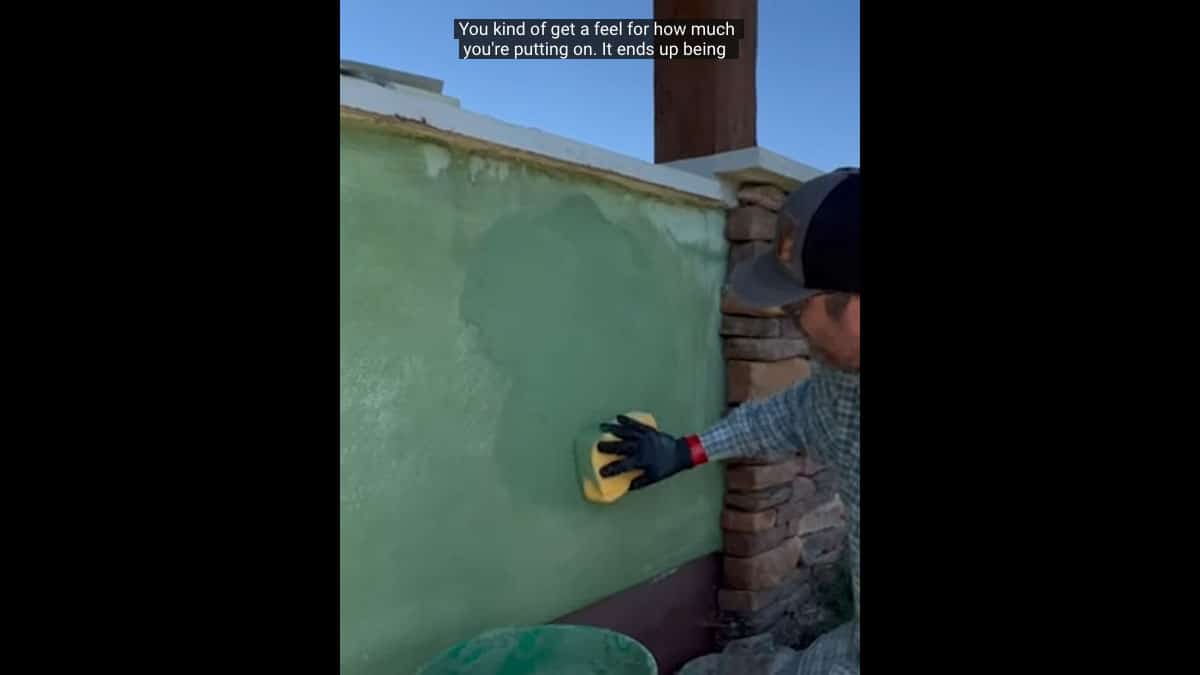 Applying a color coat with sponge technique to lime plaster finish on a straw bale house.